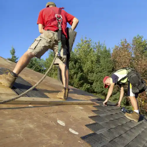 Construction Roofers wearing proper Safety Equipment